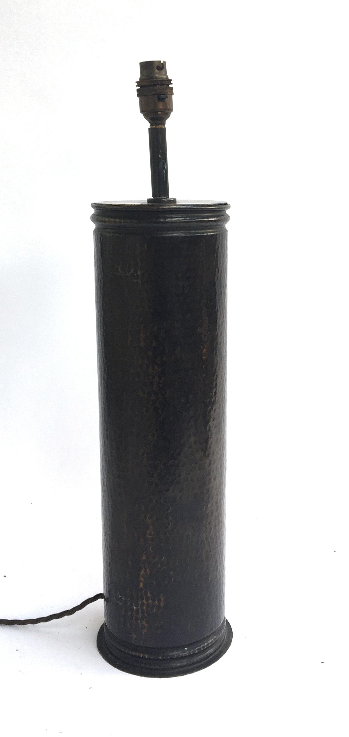 A beaten copper effect table lamp of cylindrical form, 55cmH to top of fitting