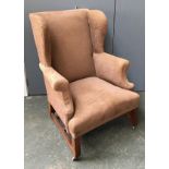 A brown upholstered wingback armchair