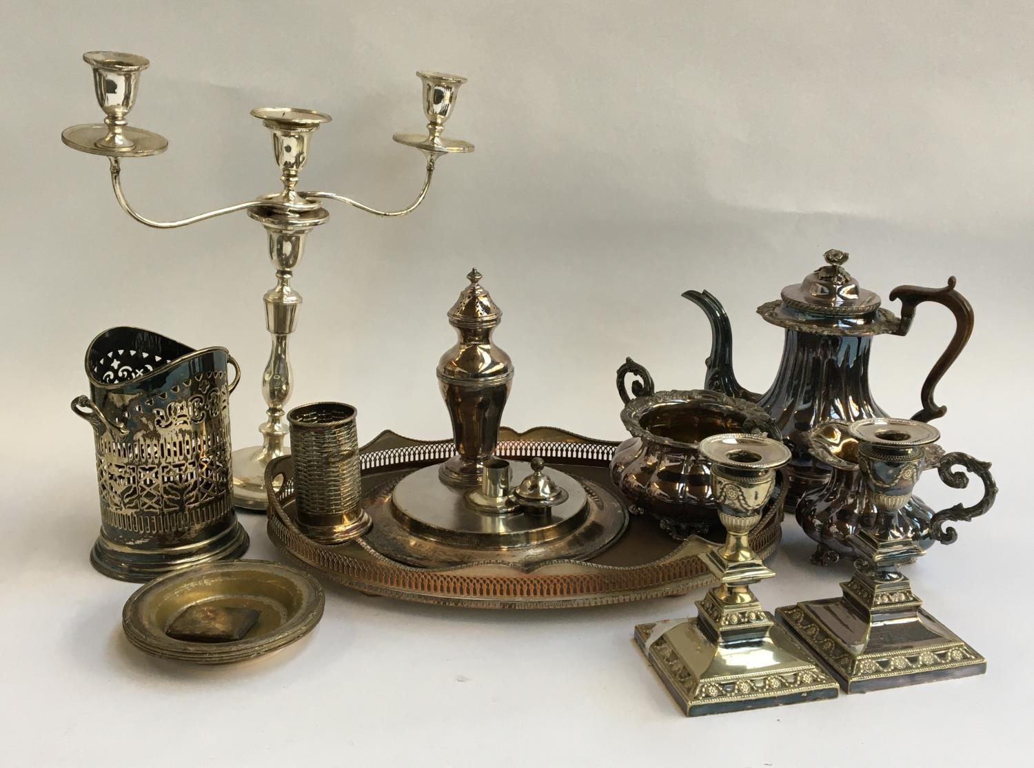 A mixed lot of plated items, to include three piece tea set, pair of candlesticks, three arm