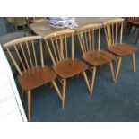 A set of four Ercol style stick back dining chairs