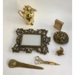 An mixed lot of brass items including Art Deco compact; heavy brass picture frame; bird character