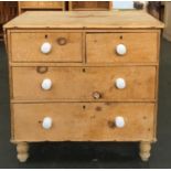 An early 20th century pine chest of two short over two long drawers, with ceramic knobs, 88cmW