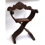 A cross frame savonarola chair with lion masks