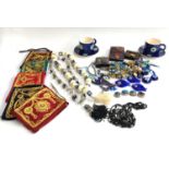 A mixed lot of Turkish glass evil eye beads and charms, glass fish fridge magnets, small wallets,