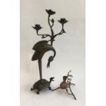 A Japanese bronze candle-holder with crane standing on tortoise, and a gilded brass early 20th
