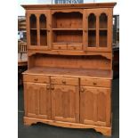 A pine dresser with glazed door above cupboard base, 138cmW, 190cmH