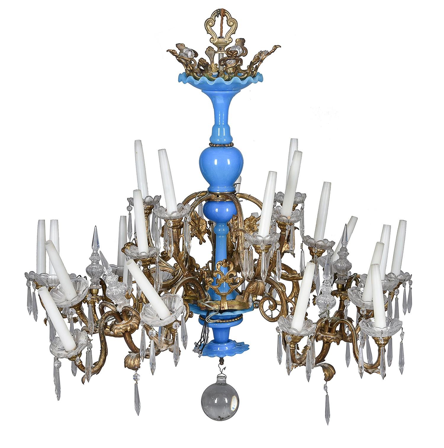 A probably Italian gilt metal and blue glass twenty four light chandelier, 20th century, the scallop