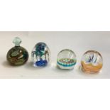 Four glass paperweights including Caithness limited edition