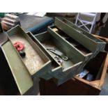 A metal toolbox containing a small quantity of spanners