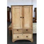 A Victorian pine cupboard, above two short and one long drawer base, the top adapted as a hanging