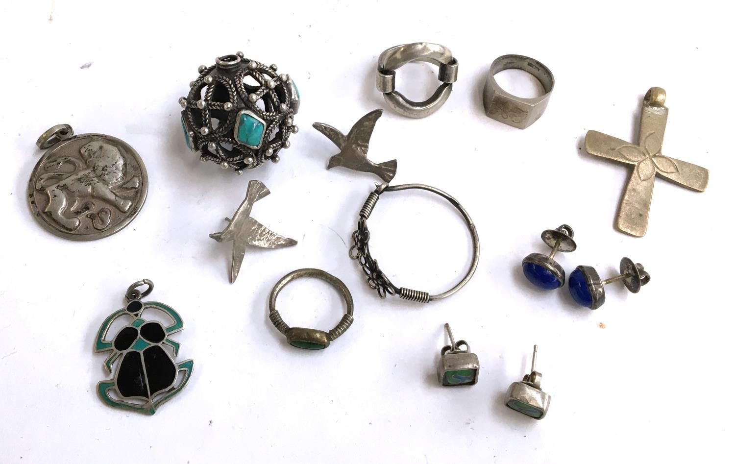 A quantity of jewellery to include rings, medals, a pierced sphere of turquoise, earrings etc