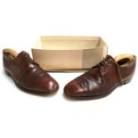 A pair of gents Church's brown lace up shoes, size 13; together with wooden trees