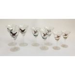 Eight glasses painted with ducks in flight, capercaillie, and pheasants