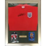 A framed display of a 1966 World Cup replica shirt signed by Geoff Hurst, in black permanent