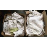 Two boxes of linen and assorted tableware