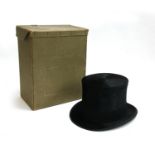 An Austin Reed black silk top hat, approx. size 7, in original cardboard box