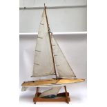 A large wooden pond yacht, on beechwood stand, 93cm long, 135cm high