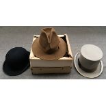 A Moss Bros. grey top hat, size 7; together with a Moss Bros. black bowler, size 7; and a Joule &