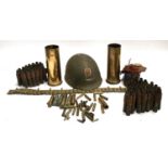 A large quantity of shell cases, various sizes, together with belt and US forces helmet cover