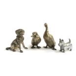 Four white metal figurines: two ducks, a Scottish terrier, and a Springer spaniel