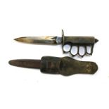 A WWI period US army trench fighting knife with brass knicke duster grip, marked marked 'U.S.