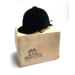 A 1950s/60s black velvet riding hat (Harry Hall Ltd., London W1), in original box, approx. size 7