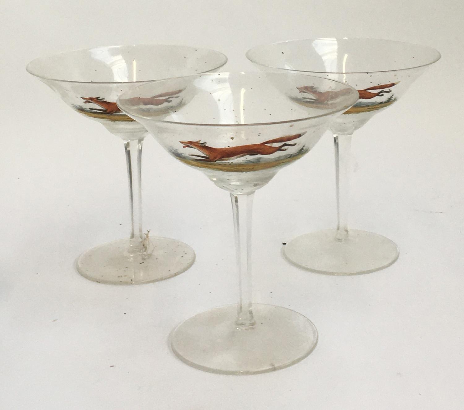 Three champagne cups, hand painted with running foxes; and four coloured glass tumblers