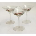 Three champagne cups, hand painted with running foxes; and four coloured glass tumblers