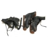 Two pairs of vintage skating boots, with blades