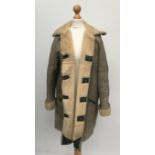 A sheepskin and green leather coat