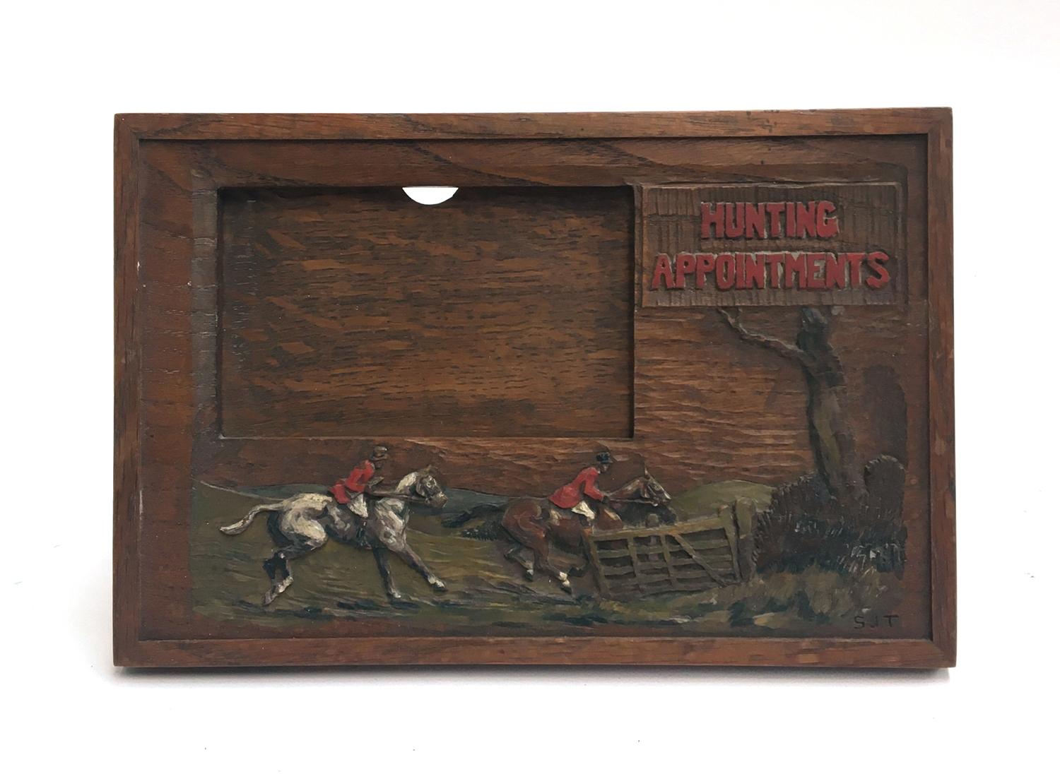 A wood carved and painted hunting appointments card holder, signed SJT lower right, and retailed