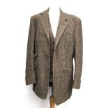 A gent's three piece tweed suit, tailored by Moss Bros., 1983, the jacket with double vent to rear