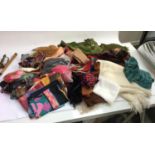 A mixed box of headscarves, some silk, scarves and wraps, gloves and socks, and fabric purses