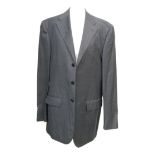 A gent's grey single breasted wool suit by John Bray, the trousers with pleated tops and turnups,