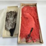 Two large vintage ostrich feather fans in their original boxes, the larger approx 70cmL