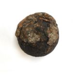 A 19th century iron canon ball, found on the beach near Burton Bradstock, approximately 3" diameter