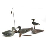 Four late 19th/early 20th century painted wooden decoys, two with stands, one broken