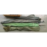 A two collapsible carp landing nets; two rod rests; two green umbrellas