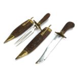 A hardwood and brass carving set comprising knife and fork, each with sheath