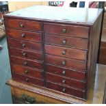 A pine specimen cabinet, having two sets of seven drawers, 39x28x34cmH