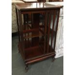 An Edwardian mahogany rotating bookshelf, strung and crossbanded, on casters, 51x51x90cmH