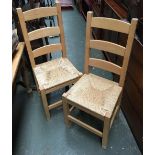 A pair of modern kitchen chairs with rush seats