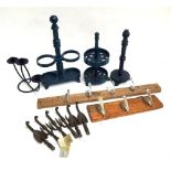 Several continental cast iron stands, two coat racks and a set of six coat hooks in the form of