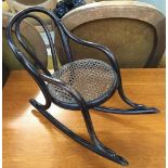 A thonet style ebonised dolls rocking chair, with caned seat, 27cmH