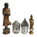 A carved wooden figure of a Buddhist monk, 63cmH; together with two Buddha busts and one other