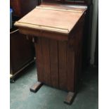 A late 19th/early 20th century pine lectern, probably used in a schoolhouse, with cupboard to front,