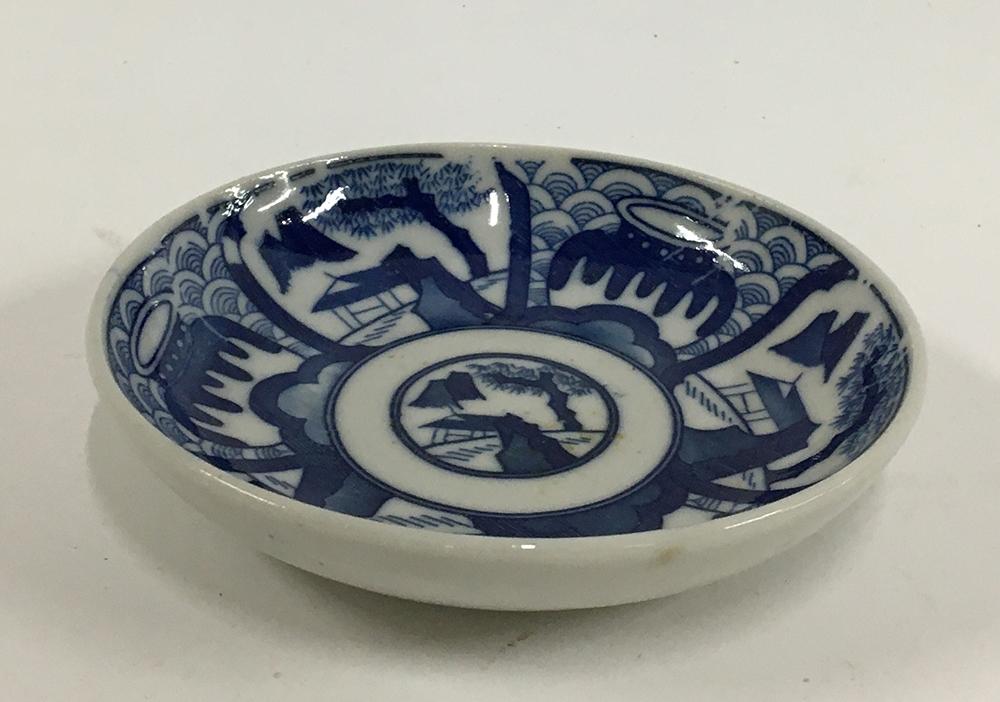 A Japanese Kozara porcelain blue and white plate, Seigaiha pattern, marks to base, 11cmD