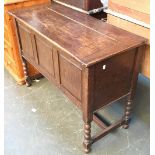 An oak three panel coffer sideboard, raised on turned legs and H-stretcher, 107cmW