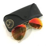 A pair of Ray Ban sunglasses, with branded cloth and case