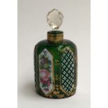 A Victorian glass bottle with hand painted floral panels, heightened in gilt, with cut glass